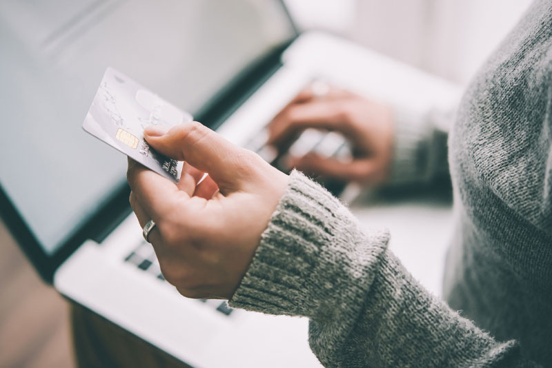 dental patient using credit card to pay for all on 4 dental implants